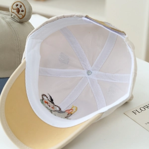 Detail of baby bear baseball cap showing white breathable mesh lining and neat stitching