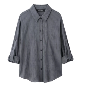 Detailed view of grey long-sleeve striped shirt with crinkle texture and buttoned cuffs