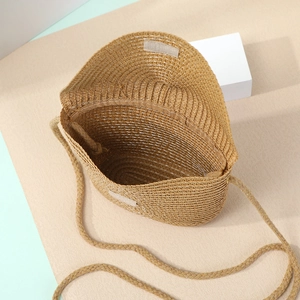 Detail of handmade straw crossbody bag showing Velcro closure and woven texture