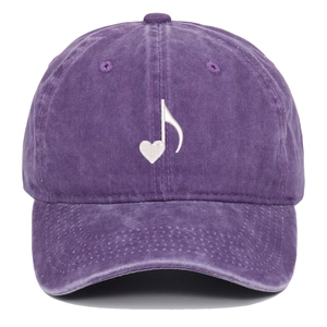 Macro view of purple washed cotton baseball cap with white heart music note embroidery