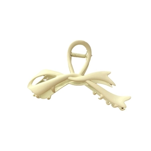 Matte cream-colored oversized bow hair claw clip with elegant streamlined design