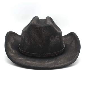 Detail of vintage distressed western cowboy hat with ethnic embossed leather band