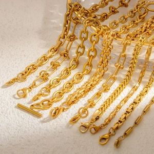 Close-up of assorted 18k gold plated titanium steel chains including snake and curb styles