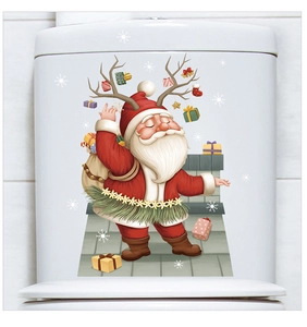 Detail of Santa Claus and reindeer decal applied on a white bathroom toilet tank cover