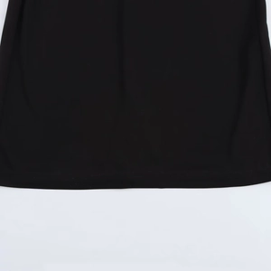 Detail shot of the smooth black knit hemline and fabric texture of the slim maxi dress