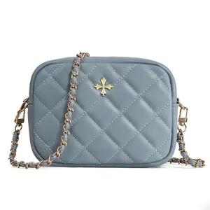 Light blue quilted crossbody phone bag with gold star clasp and metal chain strap
