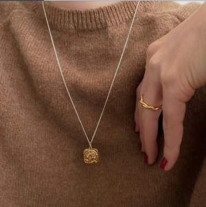 925 Sterling silver square pendant necklace and ring worn on brown knit sweater