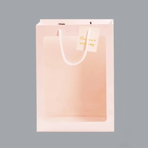 Pink gift bag detail with transparent window and handles for flowers or dolls