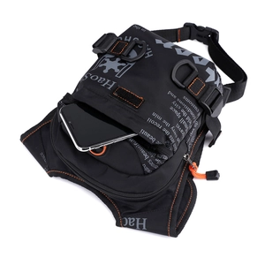 Tactical black thigh bag with orange stitching and adjustable buckle straps for sports
