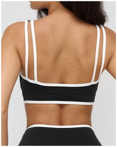 Macro detail of high-elastic back straps on black and white square-neck sports bra