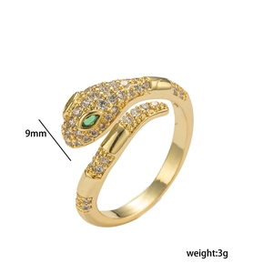 Adjustable gold snake ring featuring micro-pave white and green zircons on white background