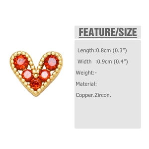 Detail view of mini heart stud earrings with red zircons and gold plated copper specs