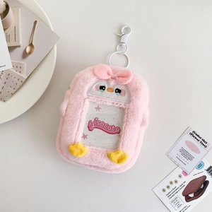Pink plush penguin card holder with white clip and transparent slot for storage