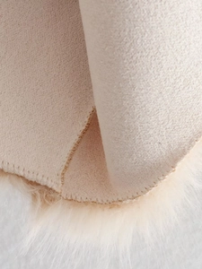 Vue macro détaillée de la fourrure synthétique beige et du daim avec coutures nettes