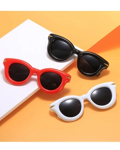 Detailed view of stylish round thick-frame sunglasses in black, red, and white on orange background