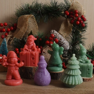 Detail showing various Christmas themed candles like Santa, snowman and tree on wood base