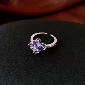 Macro shot of silver flower ring with purple zircon and sparkling pave crystals