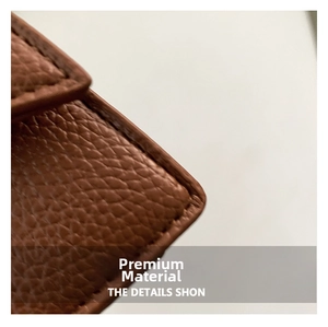Close-up of brown litchi grain leather texture and premium stitching detail
