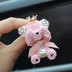 Detail of pink rhinestone teddy bear car air vent clip with gold crown and pearl pendant