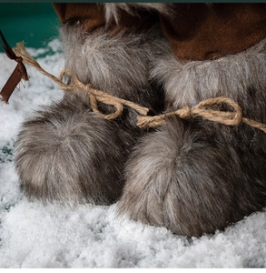Close-up of Santa doll boots with brown suede, grey faux fur and natural jute twine detail