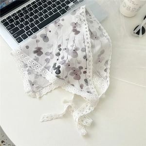 Flat lay of white floral cotton bandana with lace trim and elegant ribbon ties