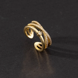 Close-up of golden multi-layer adjustable ring with cubic zirconia micro-pave detailing