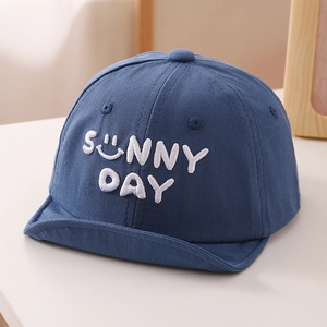 Detail of baby baseball cap showing white Sunny Day embroidery and smiley face icon