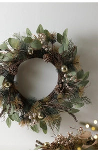 Detail of Christmas wreath with pine needles, eucalyptus leaves, pine cones and berries