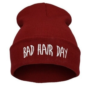 Winter knit beanie in dark red with BAD HAIR DAY embroidery on white background