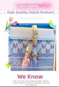 Detail of gradient heart bear keychain with glitter on a light blue patterned handbag