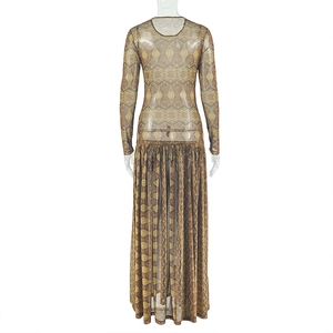 Detail of sheer mesh dress with brown and gold geometric patterns and long sleeves