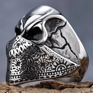 Polished silver stainless steel skull ring with paisley pattern mask on a rocky base
