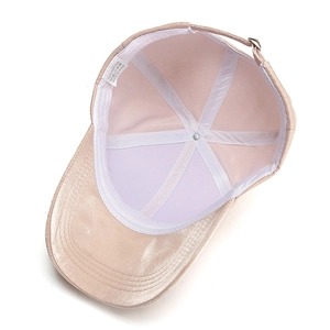 Pink satin baseball cap with metallic gold trim and adjustable metal buckle strap