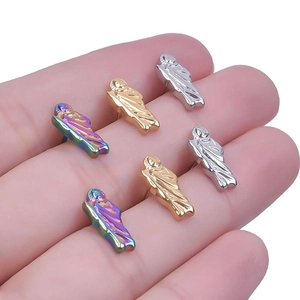 Detail view of mini saint relief stud earrings in gold, silver, and rainbow colors
