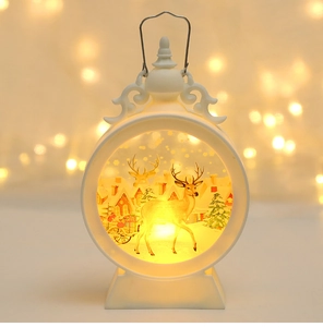 Close-up of white Christmas lantern with reindeer motif and warm LED light bokeh