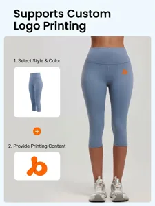 Detail of high-waisted gray-blue yoga shorts featuring an orange logo and stretch fabric
