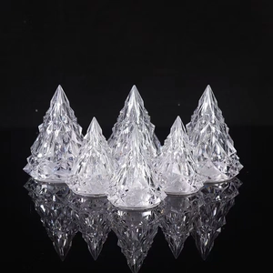Set of six iceberg-shaped crystal LED night lights on a reflective black surface