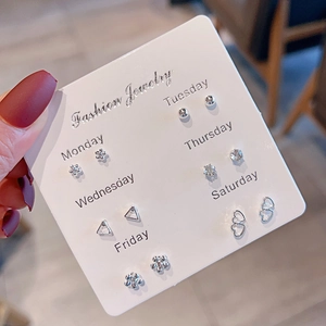 Close-up of 6 pairs of silver earrings on a card featuring hearts and floral designs
