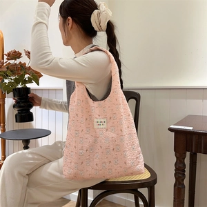 Close-up of pink bubble texture shoulder bag with cute rabbit prints and fabric label