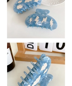 Blue marble acetate hair claw clip featuring white cloud and lightning patterns