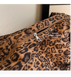 Close-up of leopard print crossbody bag featuring smooth brown zipper and silver metal slider