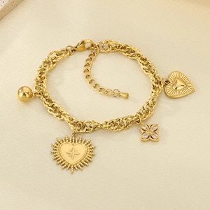 Close-up of 18K gold plated chain bracelet with heart, flower and bow charms detail