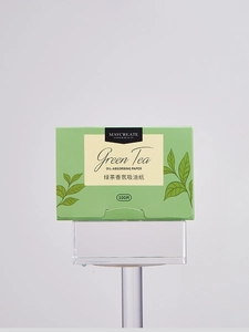 Detailed shot of green tea oil-absorbing paper box with 100 sheets for face care