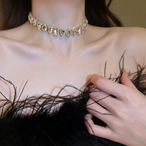Close-up of luxury choker necklace with pear-shaped rhinestones on a female model