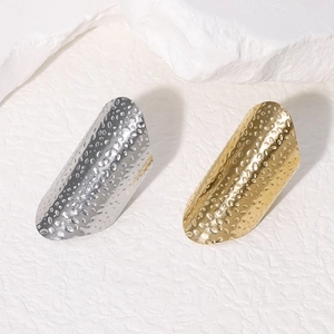 Minimalist wide hammered stainless steel rings in gold and silver finish on stone