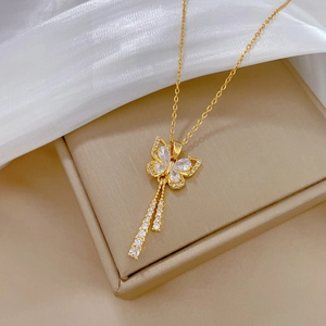 Elegant gold butterfly tassel necklace with sparkling crystals on silk and jewelry box