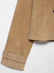 Detailed close-up of camel suede jacket showing cuff straps and premium stitching quality
