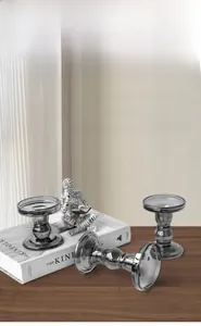 Modern smoke gray glass candle holder set on a wooden table for home decor