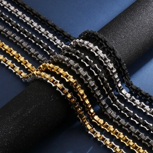 Detail view of gold, silver, and black 18K plated stainless steel necklaces for men