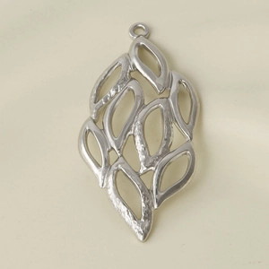 Macro shot of silver hollow leaf pendant in 304 stainless steel for DIY necklaces